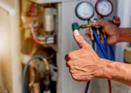 HVAC technician with thumbs up